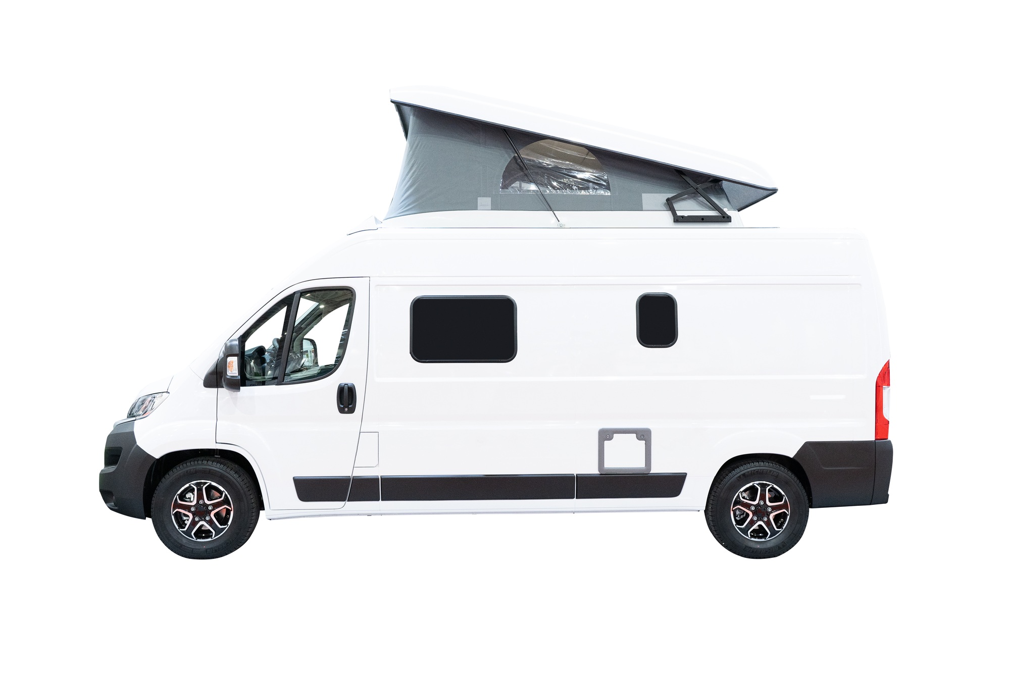 side view of white campervan RV motorhome with tent on top isolated on background
